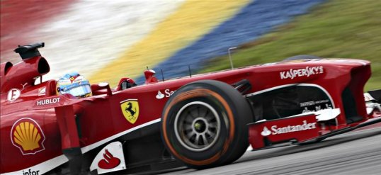 Ferrari’s Fernando Alonso is out of the Malaysian Grand Prix on lap one after clipping his front wing at the start on on the rear of the Red Bull of Sebastian Vettel.