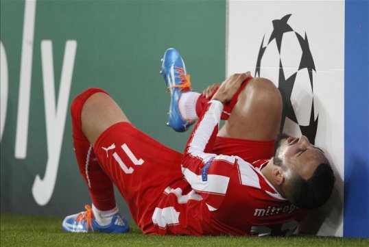 Olympiakos striker Konstantinos Mitroglou has been ruled out for at least a month after picking up a knee injury in the 2-1 Champions League defeat away to Paris Saint-Germain on Wednesday.