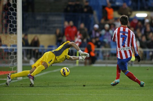 First half goals from Adrián Álvarez and Arda Turan gave Atlético Madrid a deserved 2-0 win over Getafe in La Liga.