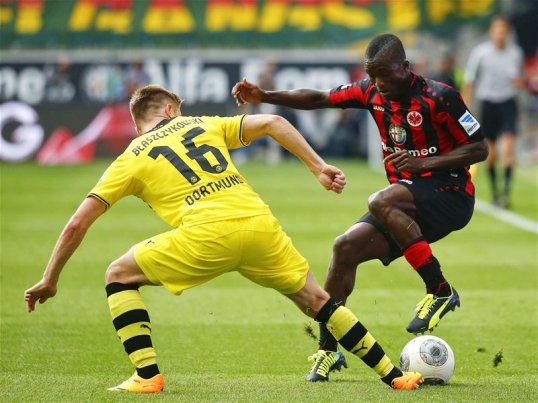 Borussia Dortmund seized the opportunity to go top in the Bundesliga by beating Eintracht Frankfurt 2-1 away on Sunday.