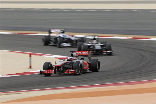 McLaren’s Jenson Button tells his team engineers to “calm him down”, referring to his teammate Sergio Perez who bumps the rear of Button as they battle for fifth.
