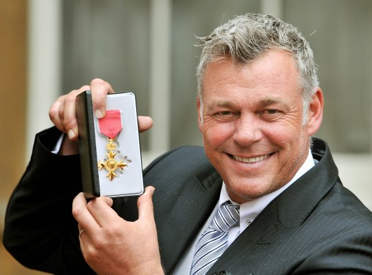 Ryder Cup vice-captain Darren Clarke has received an OBE from the Queen for his services to sport.