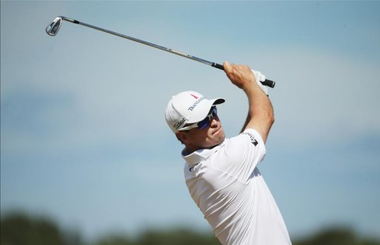 Zach Johnson holds the lead at The Open at Muirfield after shooting a five-under-par 66 in the opening round.