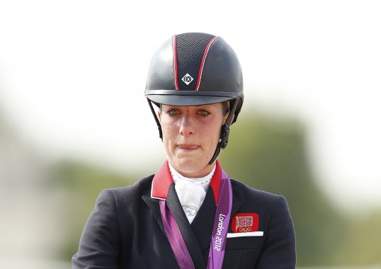 Olympic champion Charlotte Dujardin has set a new dressage grand prix world record at the London International Horse Show.
