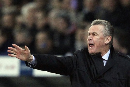 Switzerland manager Ottmar Hitzfeld has been charged by Fifa for making an obscene hand gesture towards the referee during their World Cup qualifier against Norway.