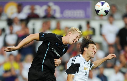Spanish star Michu gave Swansea City a narrow lead to take into half-time in their Europa League third qualifying round clash with Malmo.