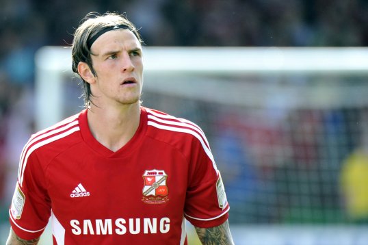 Swindon Town defender Aden Flint has been banned for four games by the Football Association following his red card in Swindon's FA Cup first round defeat to Macclesfield.