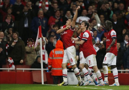 Arsenal kept their Champions League qualification dreams alive with an emphatic 4-1 victory over Wigan Athletic at the Emirates Stadium on Tuesday night.