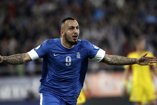 Greece are a step closer to securing their place at the World Cup finals in Brazil next summer after beating Romania in the first leg of their play-off in Piraeus.