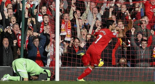Liverpool’s Luis Suarez netted his first Anfield hat-trick as his side beat West Brom at home to keep up the pace with Premier League leaders Arsenal.