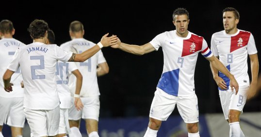 Netherlands secured their place at the 2014 World Cup with a battling victory over a spirited Andorra on Tuesday evening.