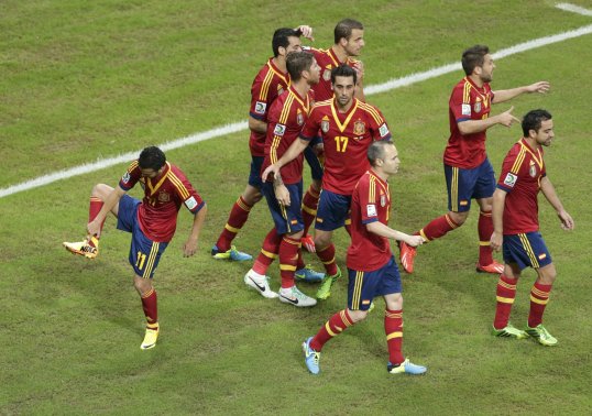 Spain survived a late scare to defeat Uruguay in their Confederations Cup opener on Sunday evening.