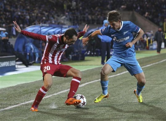 Zenit St Petersburg kept their Champions League hopes alive after a 1-1 draw at home to Atletico Madrid.