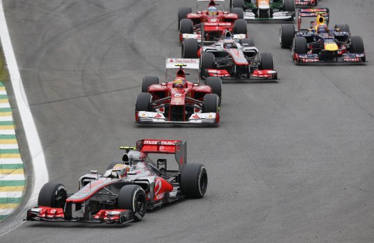 Force India’s Nico Hulkenberg leads the Brazilian Grand Prix after a thrilling battle with Jenson Button.