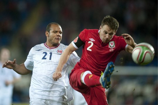Chris Gunter will become the youngest player in history to earn 50 caps for Wales when they take on Belgium in a World Cup qualifier on Tuesday night.