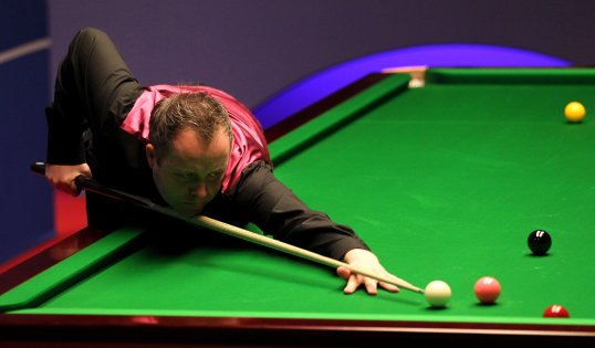 John Higgins has been knocked out of the first round of the International Championships in China.