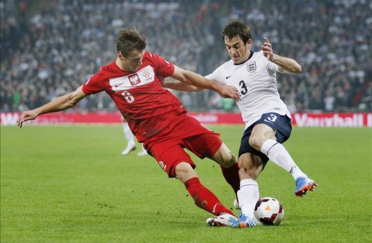 England are 45 minutes away from the 2014 World Cup finals after striker Wayne Rooney gave them a 1-0 half-time lead over Poland at Wembley.