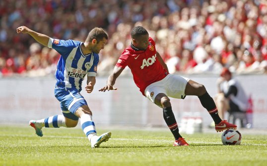 A superb Robin van Persie goal gave Manchester United a slender half-time lead over Wigan Athletic in the Community Shield this afternoon.