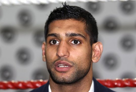 Boxer Amir Khan has had a difficult twelve months but hopes to improve in the coming year under new trainer, Virgil Hunter.