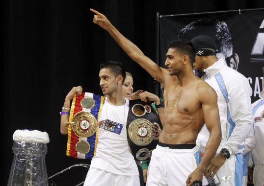 Former two-time world champion Amir Khan and his younger brother Haroon Khan fought back against six car thieves in the early hours of this morning.