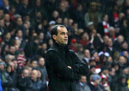 Malaga are interested in ex-Wigan Athletic manager Roberto Martinez as a replacement for the outgoing Manuel Pellegrini.