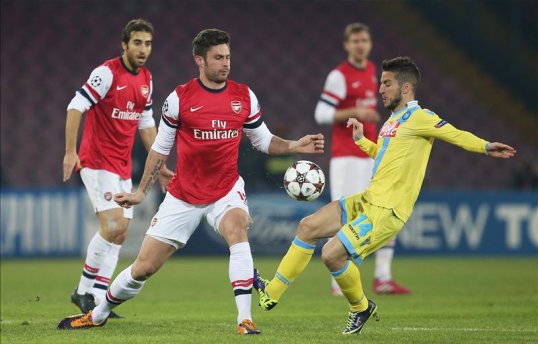 Arsenal survived a late scare to progress into the knockout stages of the Champions League, losing 2-0 at Napoli.