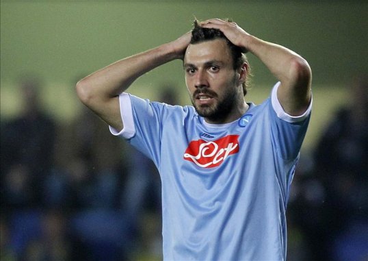 Andrea Dossena has completed a six-month loan move to Palermo from Serie A rivals Napoli.
