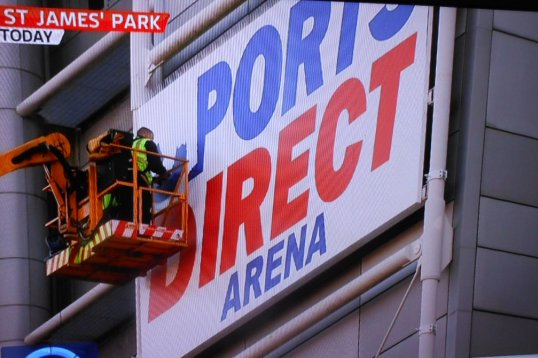 Workmen have begun work to tear down the Sports Direct signs at St James' Park.