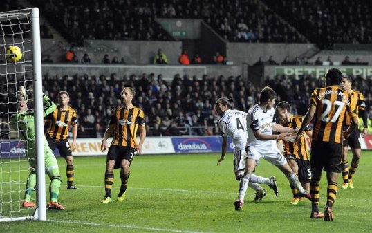 Swansea City came back from a goal down to earn a point against Hull City at the Liberty Stadium and move up to 10th place in the Premier League.