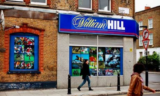 Bookmaker William Hill has bowed to legal pressure and suspended its online betting operations in Greece.