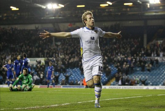 Leeds United manager Neil Warnock has played down speculation that forward Luciano Becchio is ready to leave the Championship side.