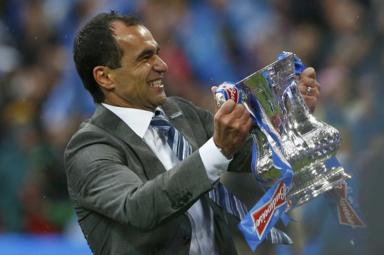 Arsenal manager Arsene Wenger believes Wigan Athletic boss Roberto Martinez could replace him at the Emirates if he were to leave.
